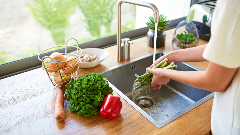 washing vegetables at the sink
