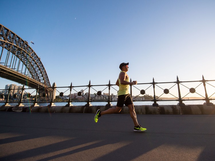Male runner running in the morning with a bridge in the background