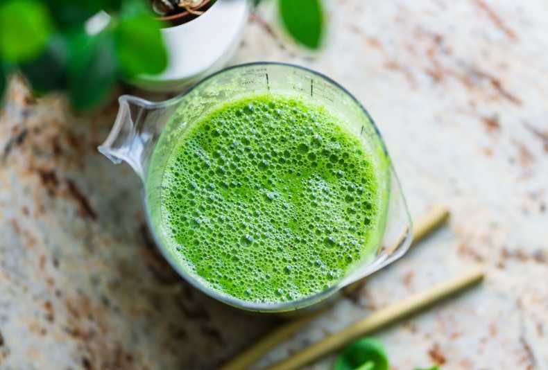Green smoothie on a kitchen counter