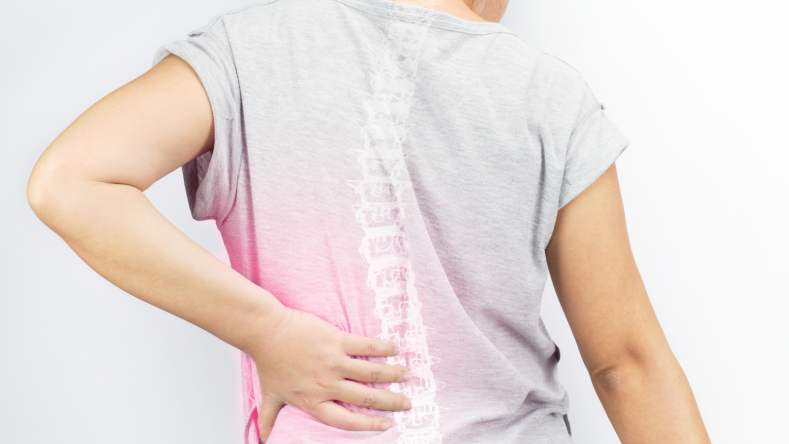 Woman with back pain in a gray tshirt