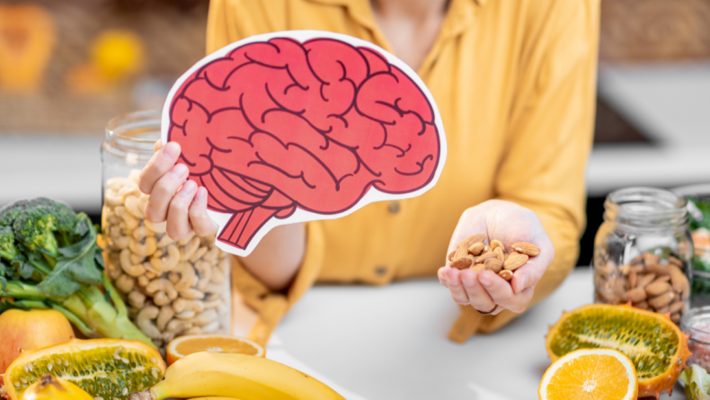 woman holding a picture of a brain with brain-healthy foods