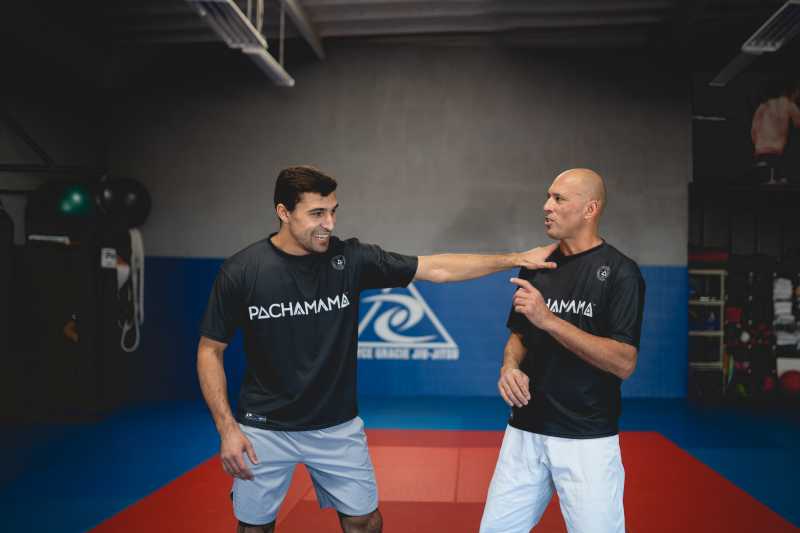 A photo of 2 people teaching MMA