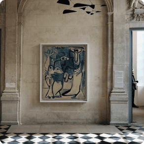 Modern art painting hanging on a wall inside a stone building
