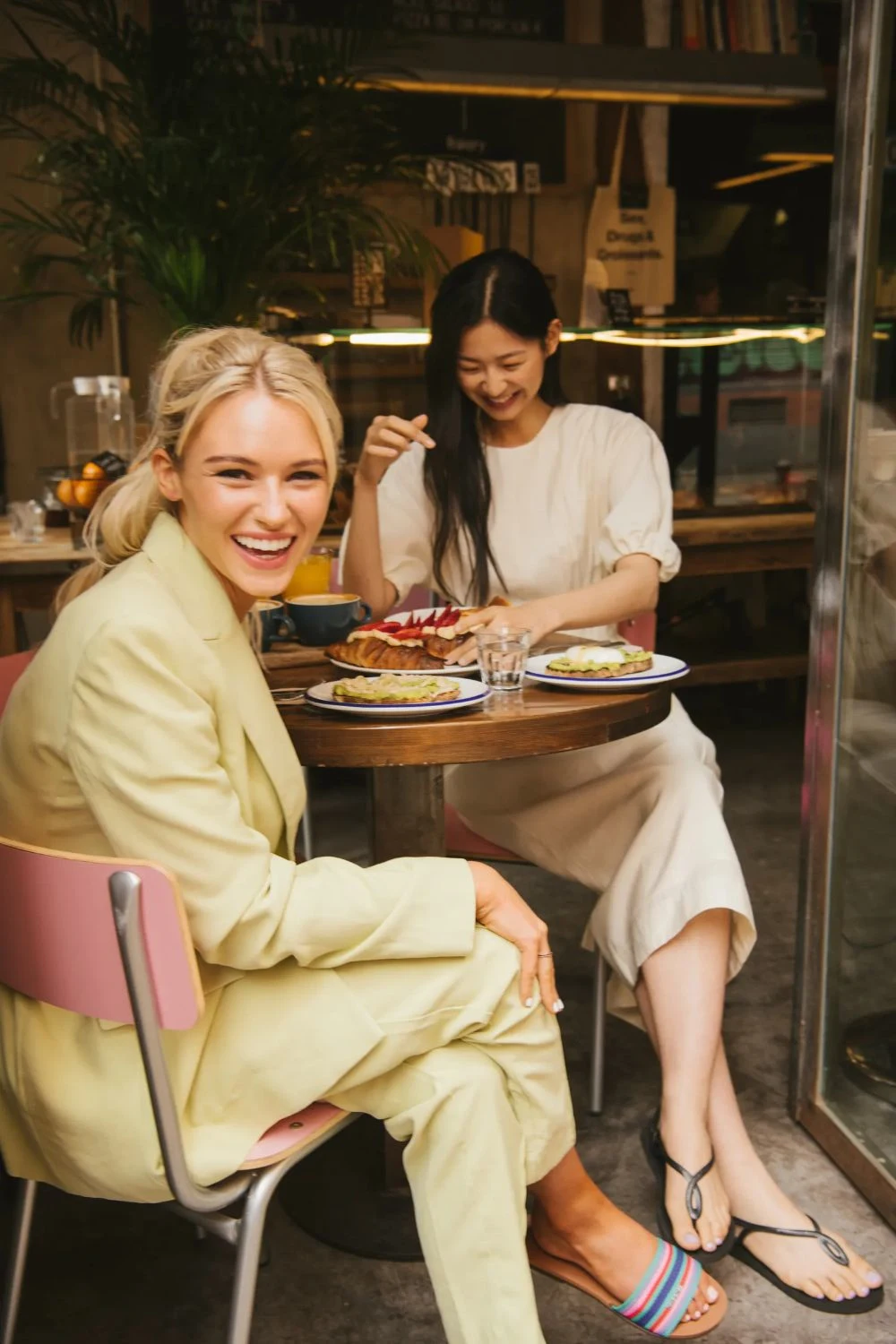 Lady smiling and eating at a restaurant - PNG
