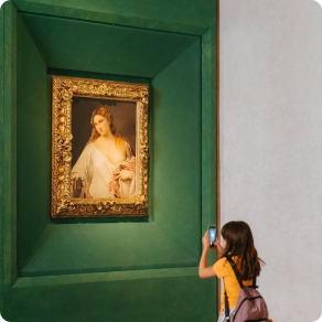 Little girl takes a photo of a painting of a woman