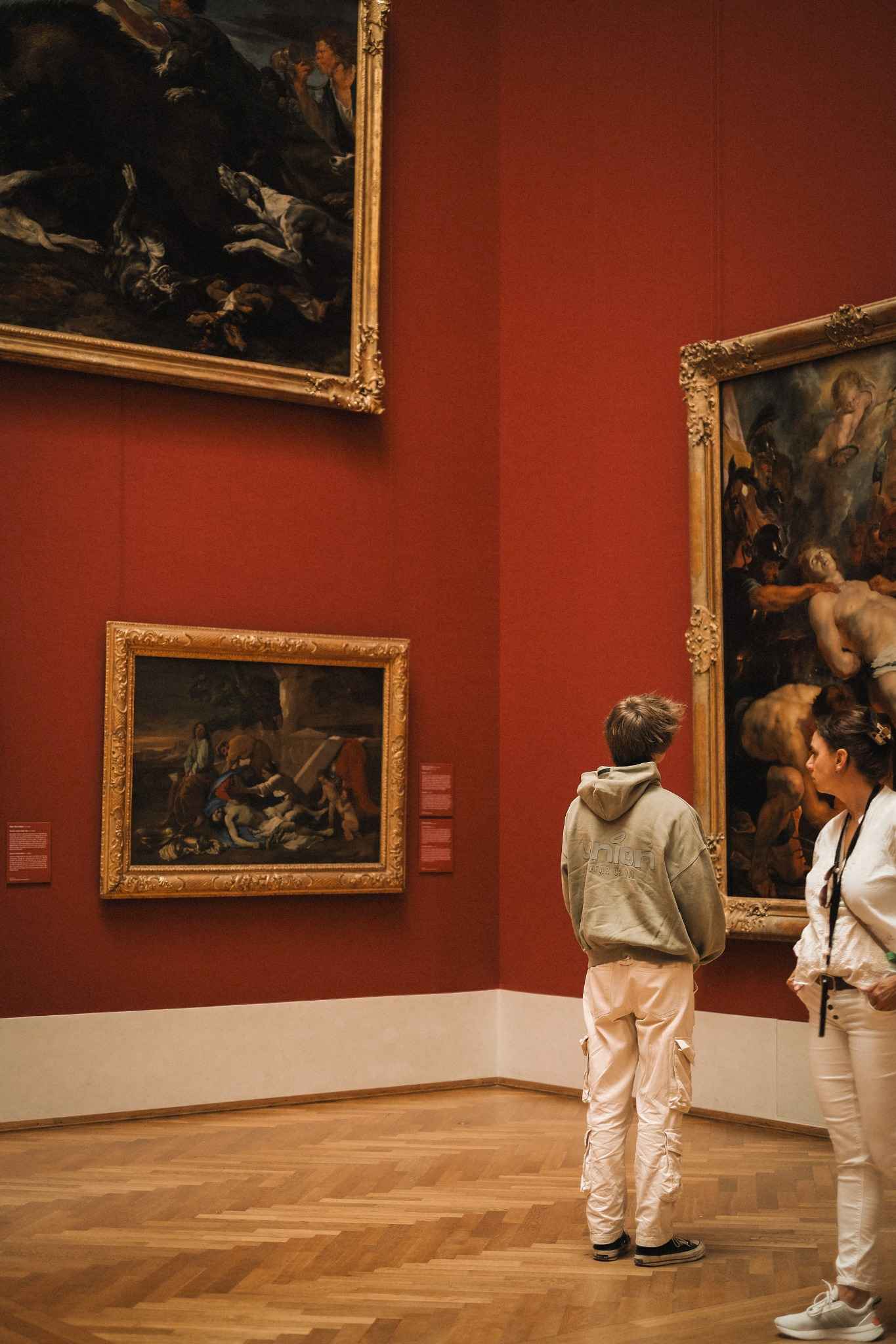 Children take a photo of a painting in a museum 