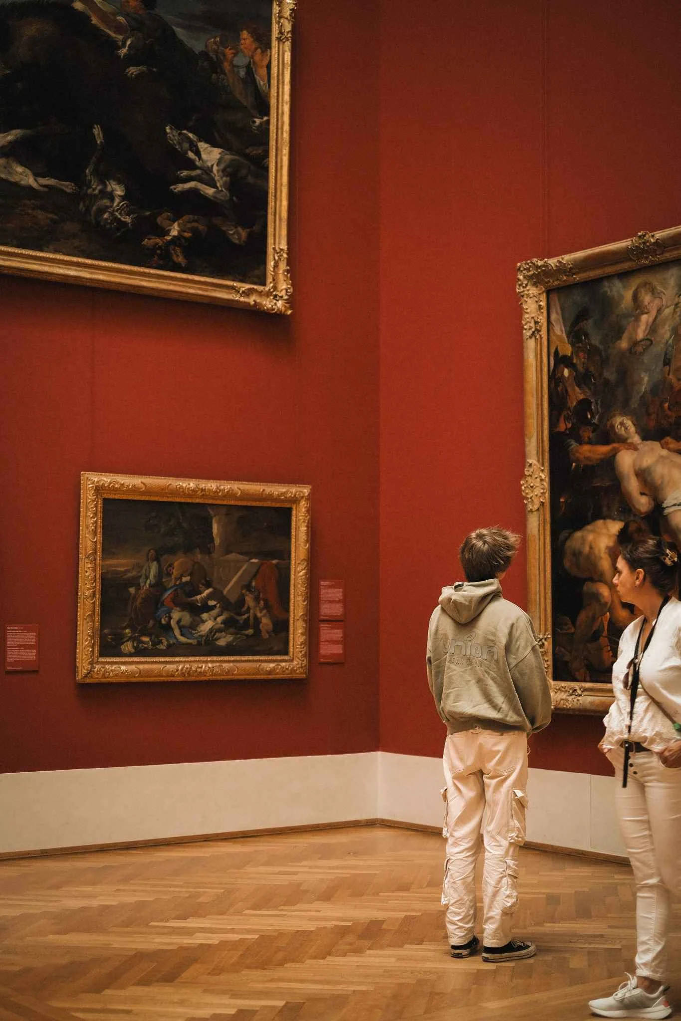 Children take a photo of a painting in a museum 