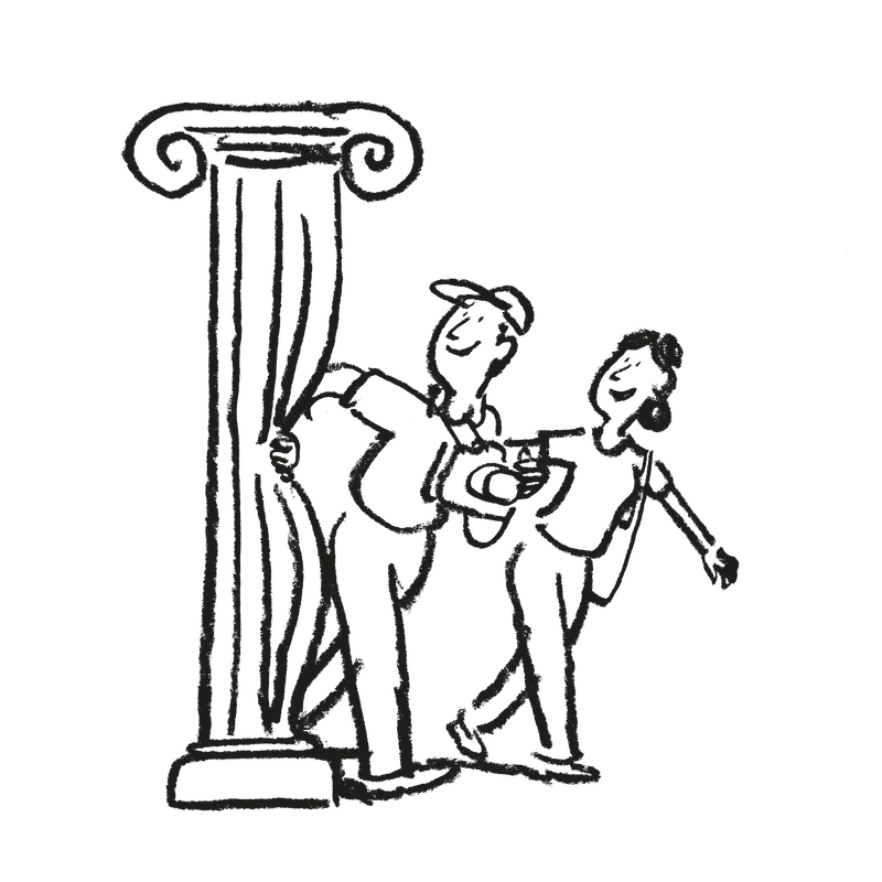Couple walks past classical marble column
