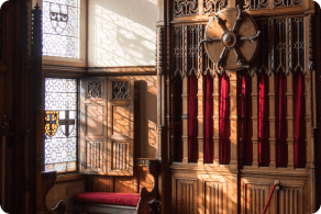 Sun streams in through stained glass in an English castle