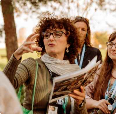 Guide speaking to group while on a walking tour of the Appian Way in Rome