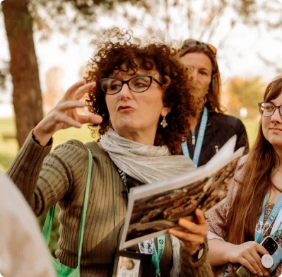 Guide speaking to group while on a walking tour of the Appian Way in Rome