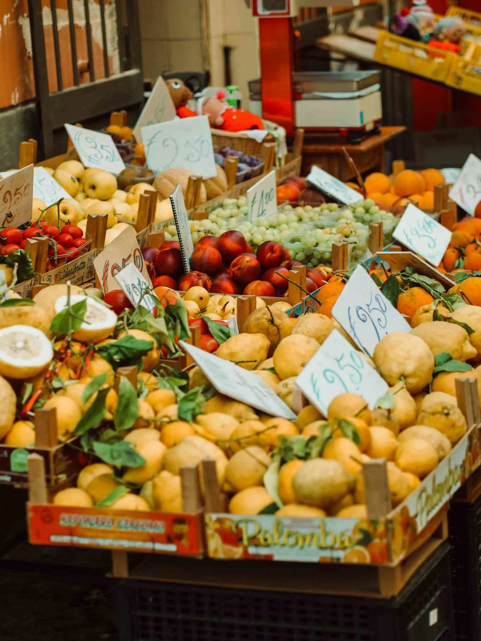Vising a fruit and vegetable vendor during WalksDevour's food tour to Venice's Rialto Market