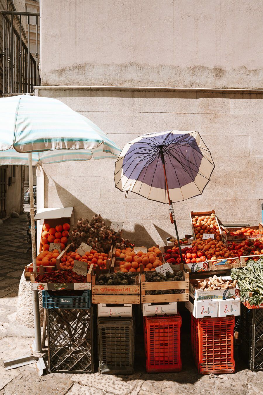 Vising a fruit and vegetable vendor during WalksDevour's food tour to Venice's Rialto Market