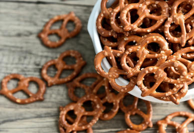 An overflowing bowl of salty brown pretzels