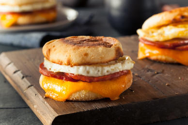 A frozen egg and ham sandwich, baked with melted cheese.