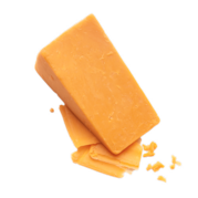 A large block of cheese sitting atop a few small slices.