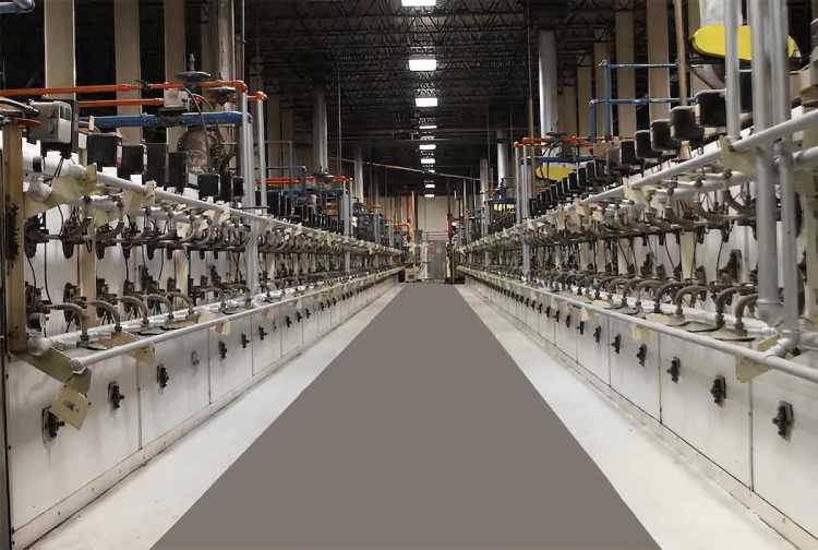 A long hallway filled with manufacturing equipment