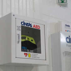A Cintas AED defibrillator in a safety compartment