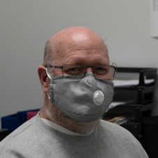A masked Hearthside worker wearing a grey mask