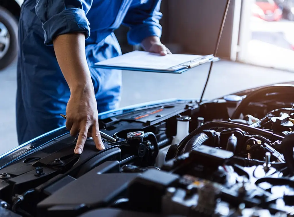 mechanic looking at car