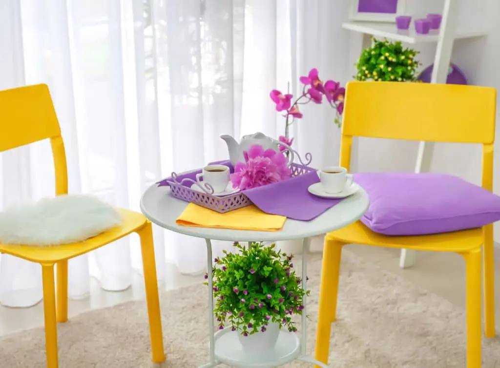 Bright yellow chairs with purple cushions in an otherwise neutral living room