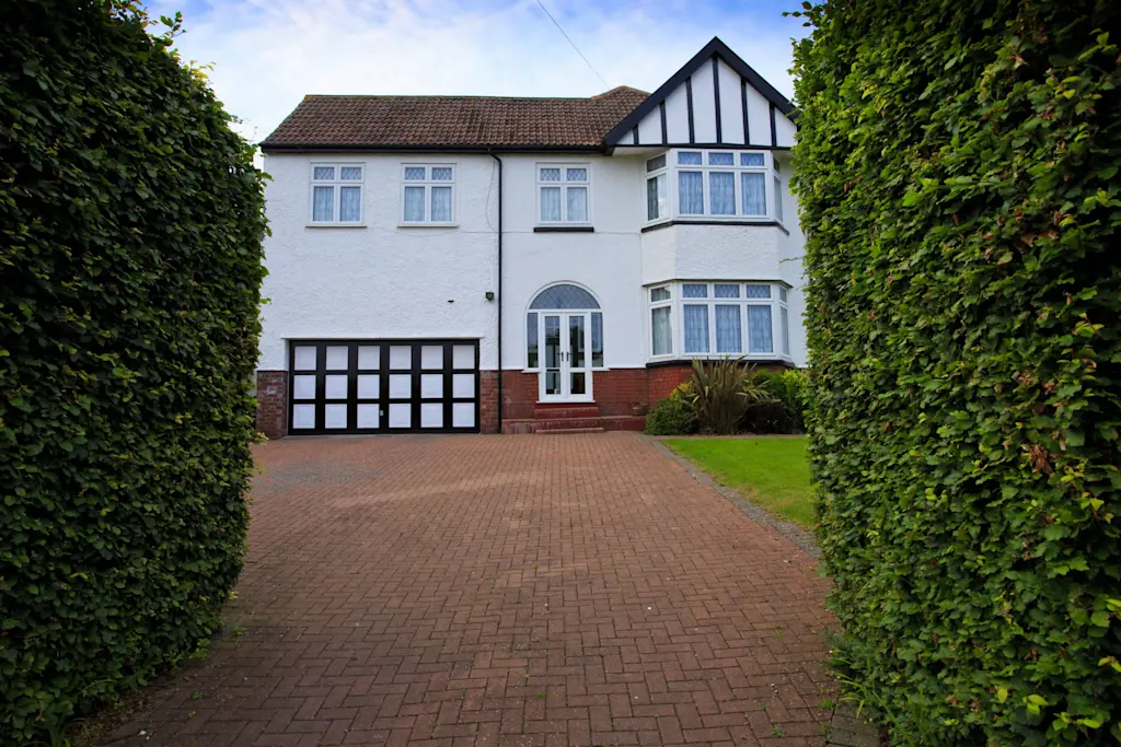 Typical 1930s white semi detatched house with large driveway