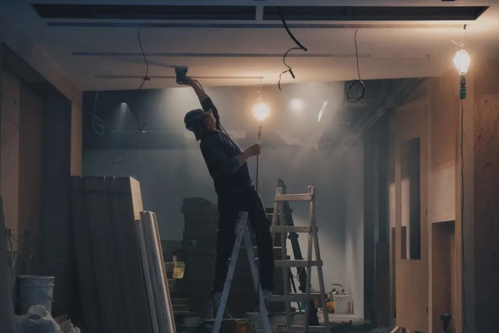 man balancing on a ladder