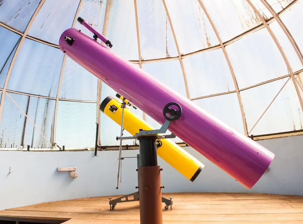 Pink and yellow telescope in white dome observatory. Blog for How to build your own observatory.