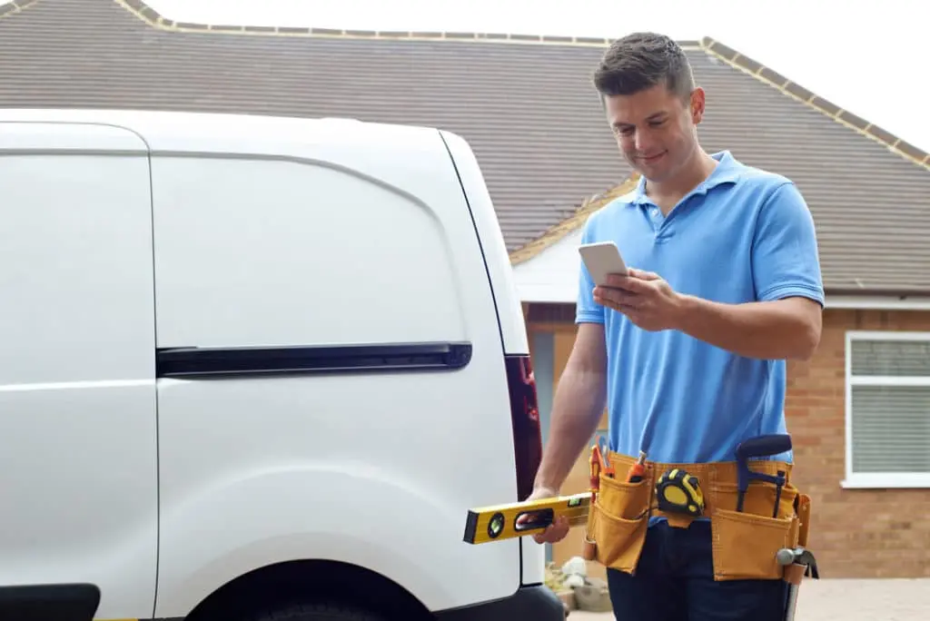 tradesman using mobile phone