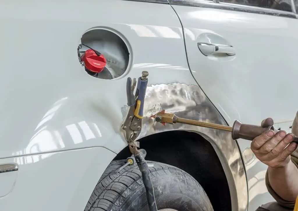 Car damage being repaired by professional mechanic