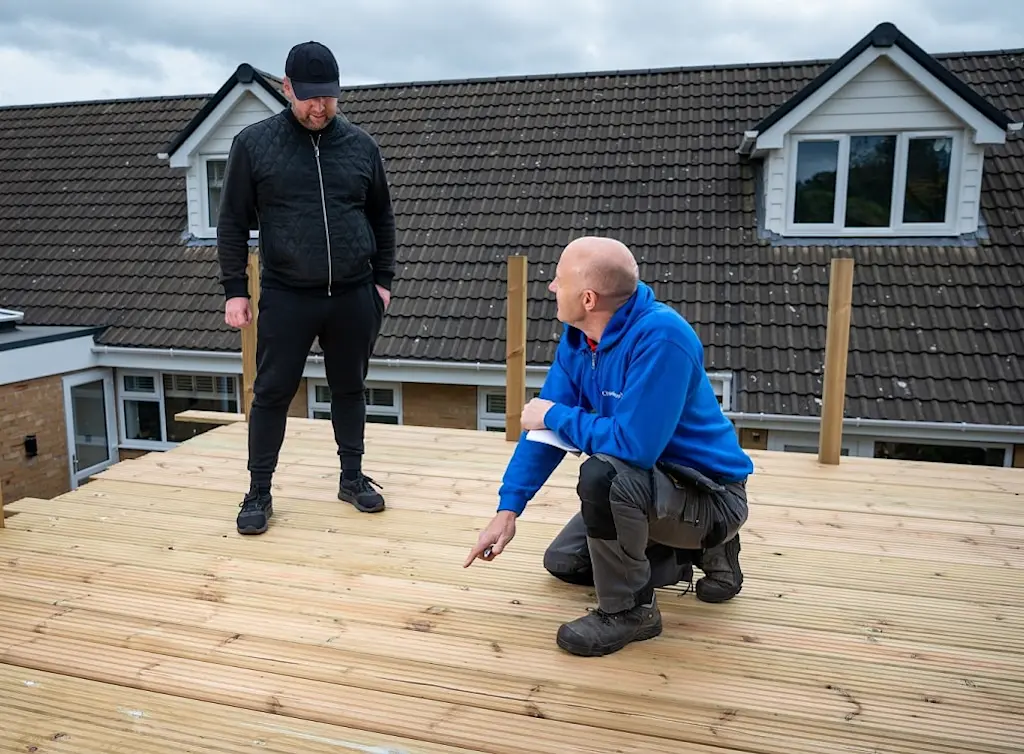 https://www.checkatrade.com/blog/wp-content/uploads/2022/11/tradesperson-selling-decking-services.jpg