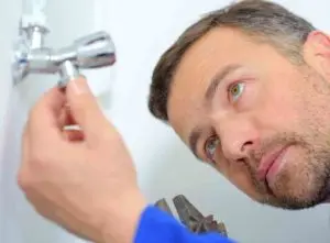 Plumber inspecting electric shower not working