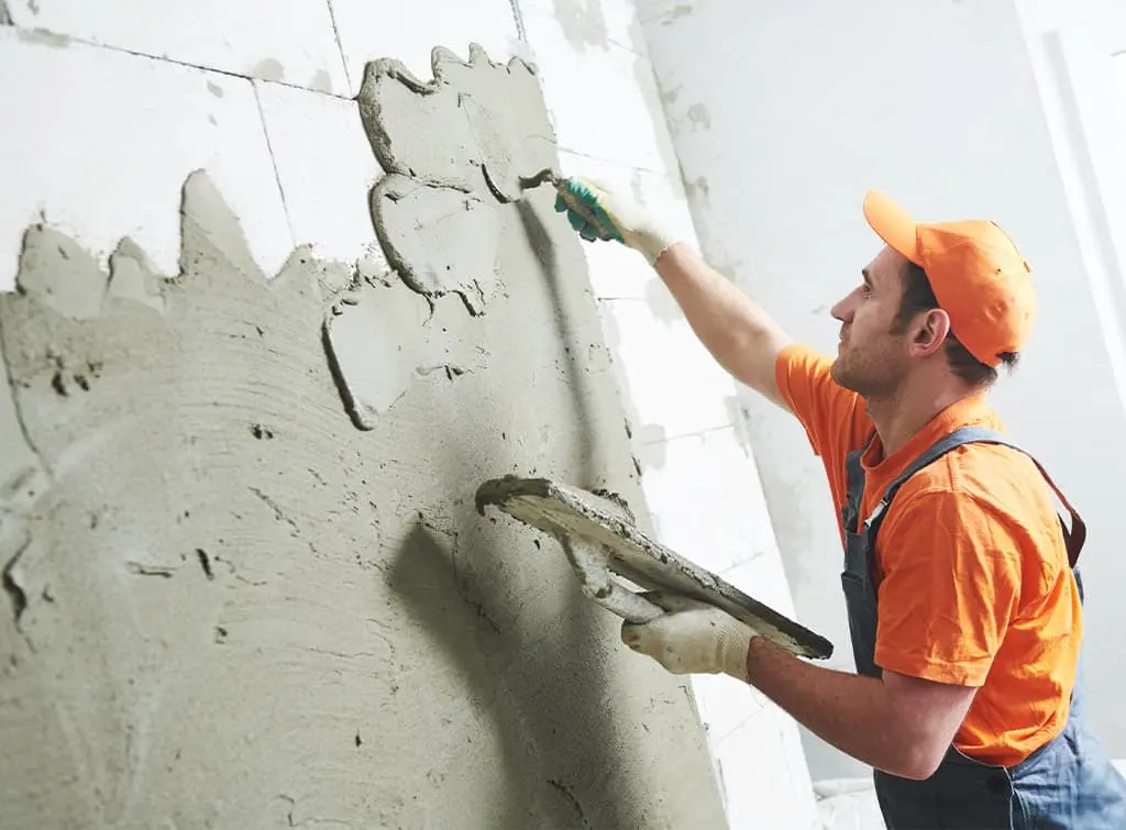Professional dry plastering a wall