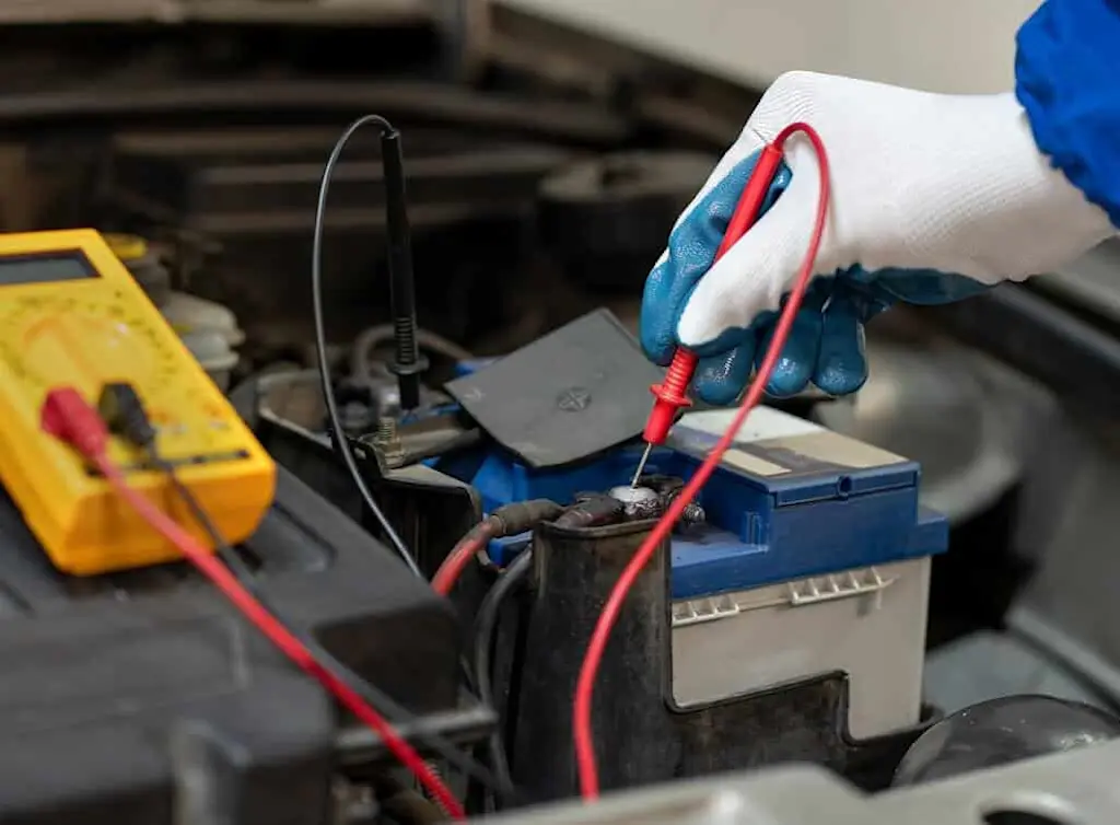 https://www.checkatrade.com/blog/wp-content/uploads/2025/02/auto-electrician-testing-battery.jpeg