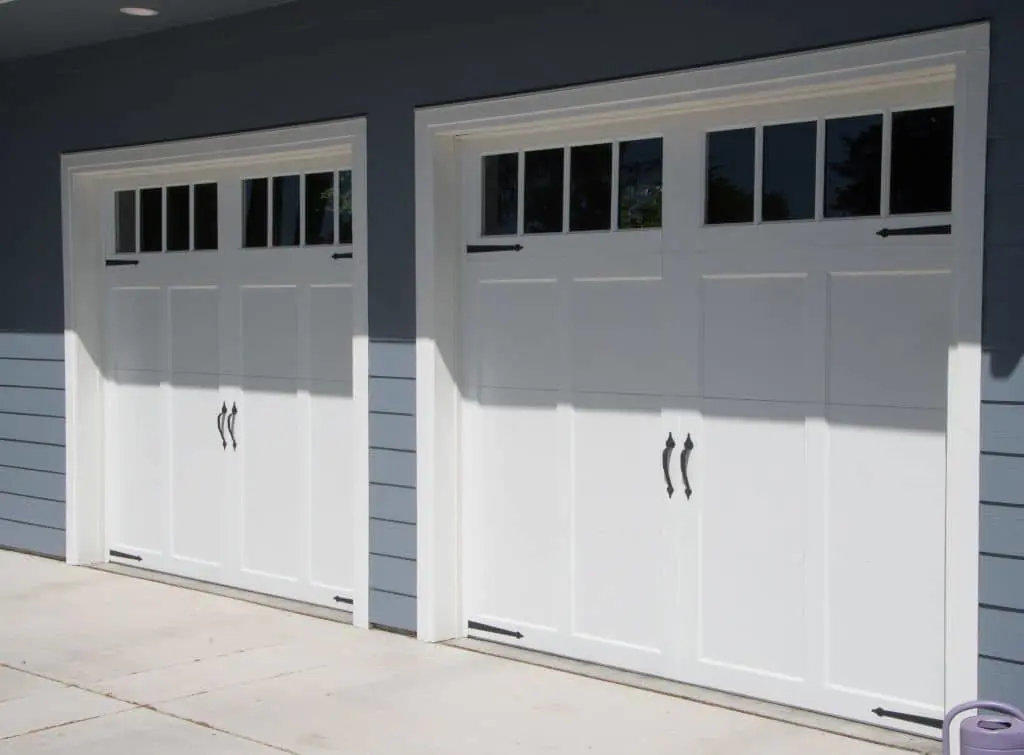 Carriage style garage doors - two white designs side by side