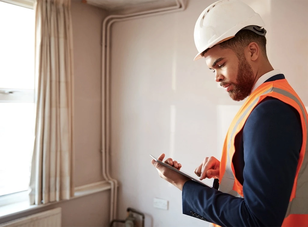 Surveyor carrying out house survey in the UK