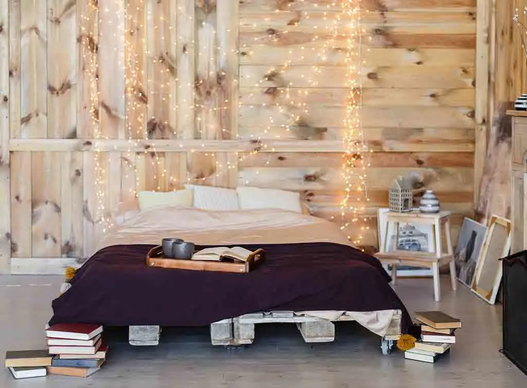 drape fairylights over bed lighting idea