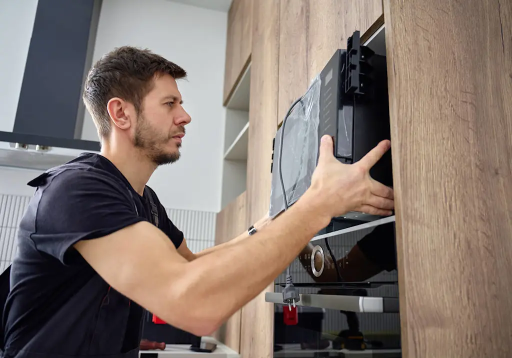 engineer-installing-built-in-microwave