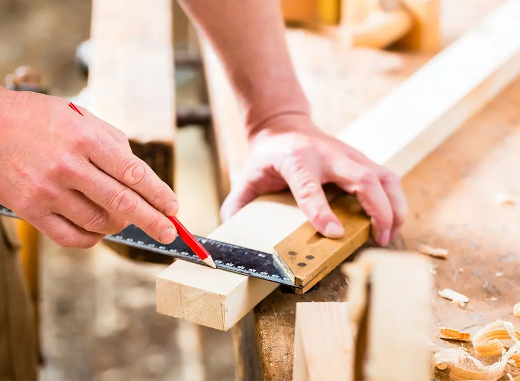 Cabinet maker measuring a cut