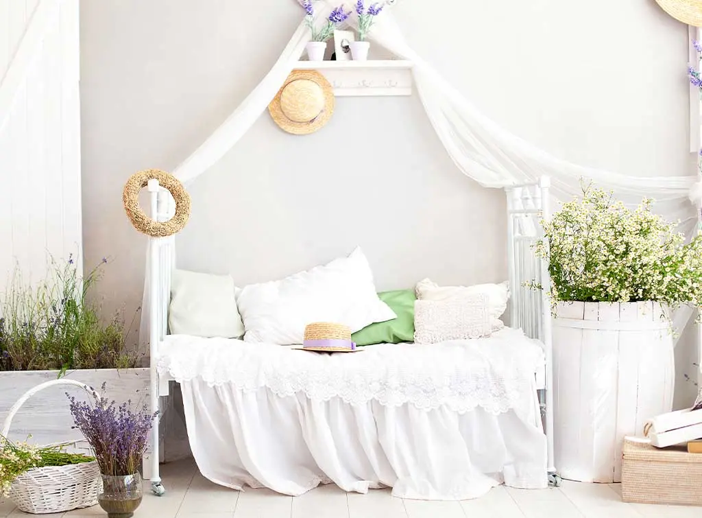 drape sheer curtains over a bed