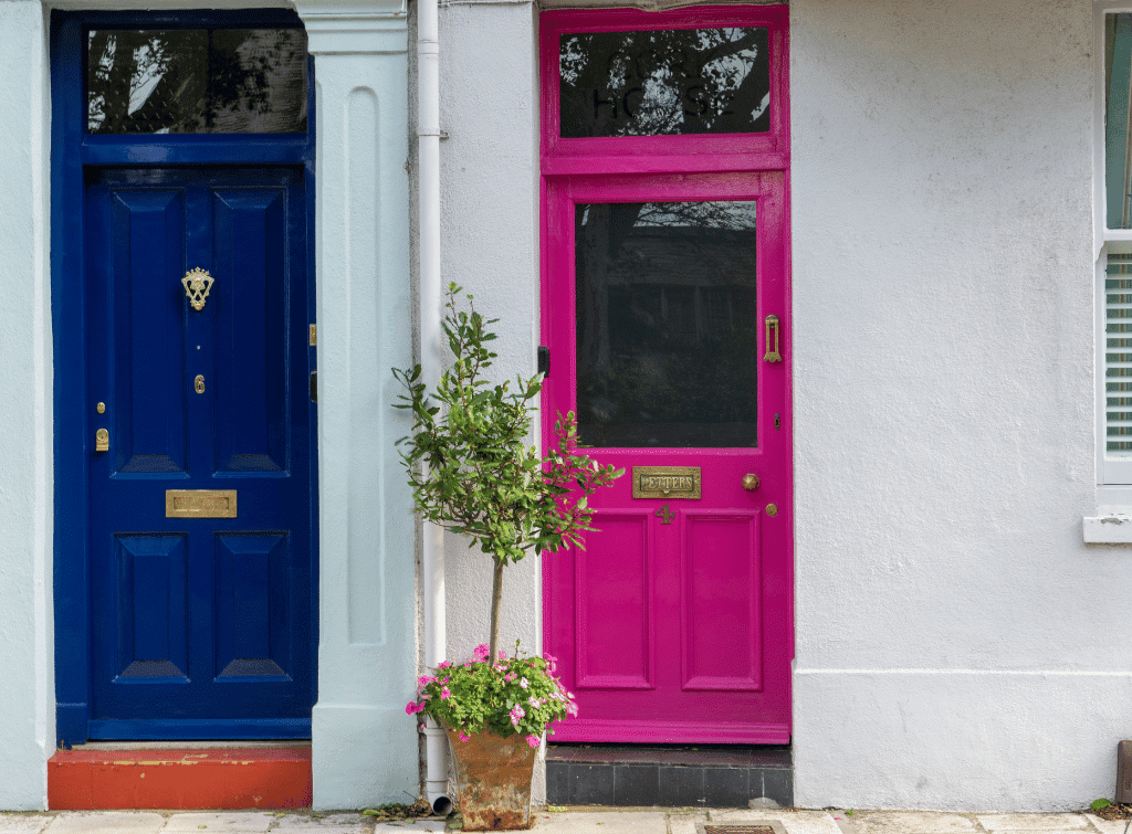 Painted pink front door along a street