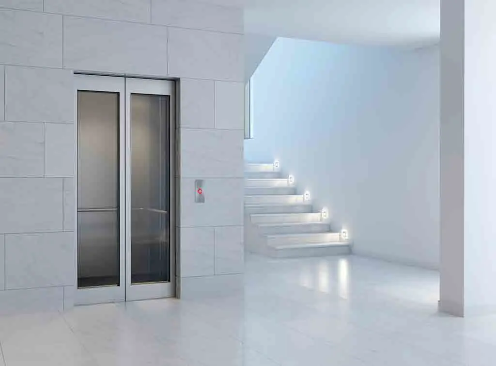 Home lift in a white room with white stairs - domestic lift cost