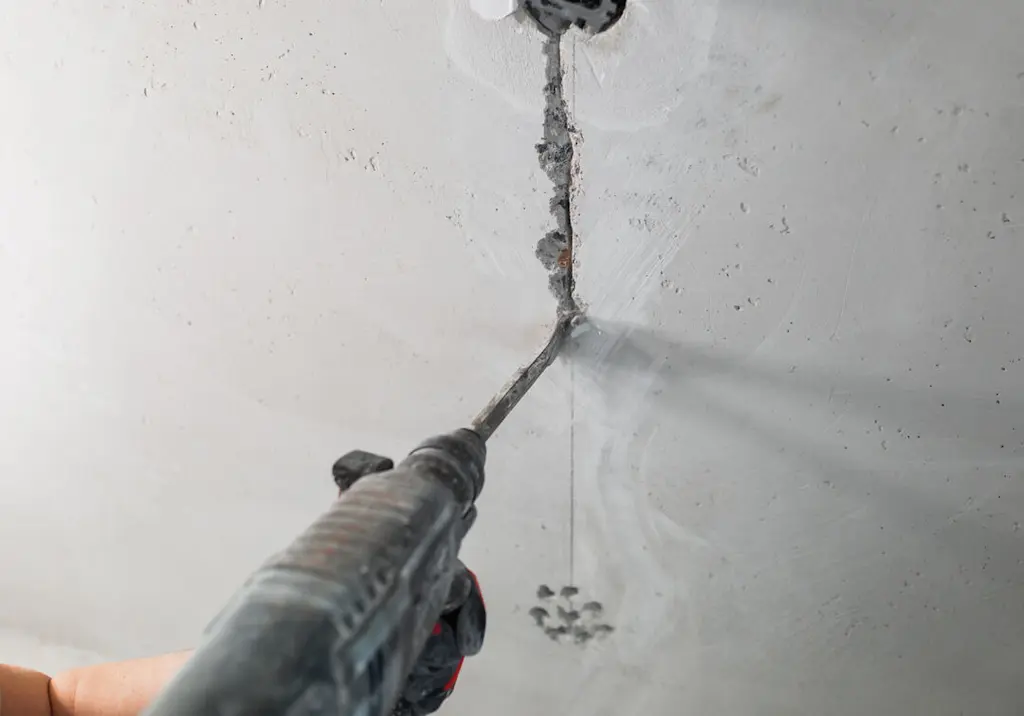chasing-out-wall-crack-with-chisel