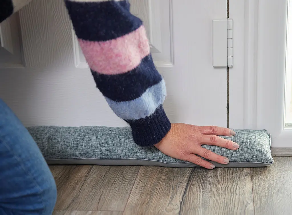 A cushion draught excluder at the bottom of the door