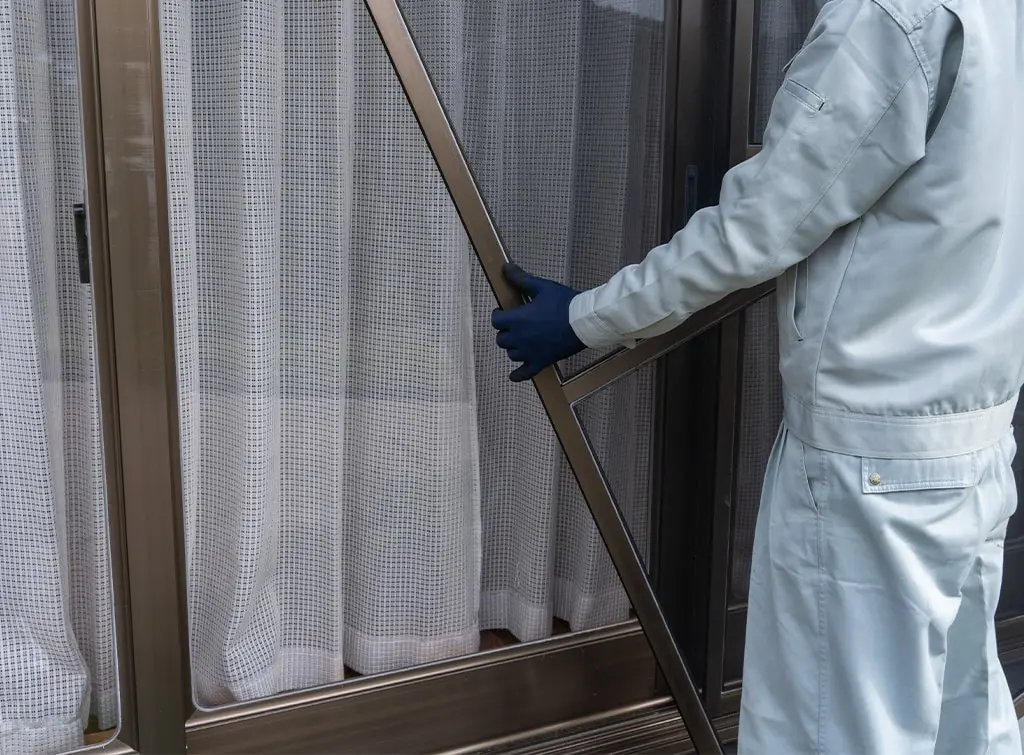 man installing door screen