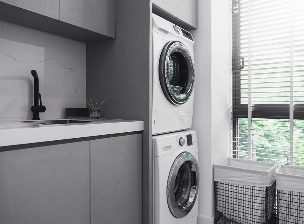 stacked washing machines in utility room
