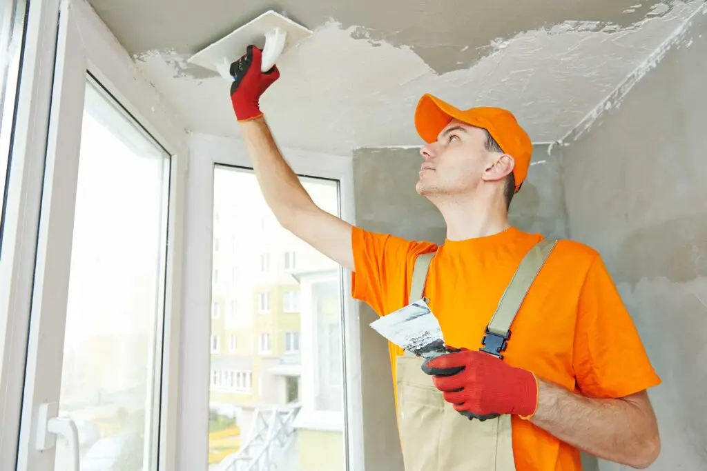 Professional plasterer working on a home