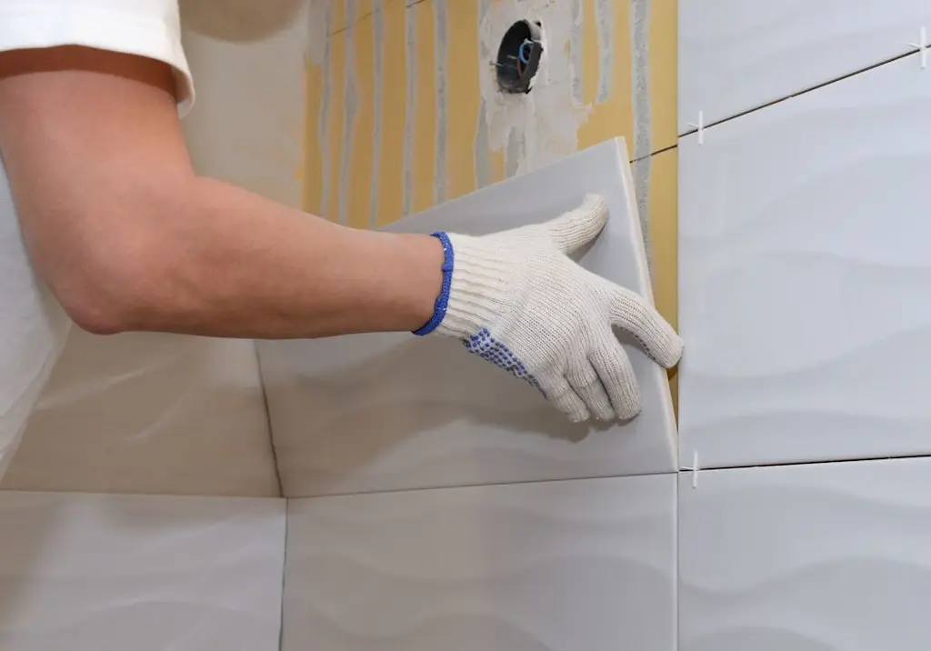 Tiler fitting wall tiles resized