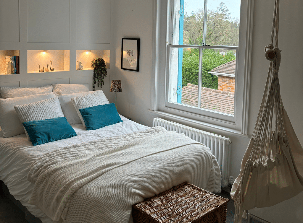 A hammock-style hanging chair adds a unique touch to the guest bedroom in the House with the Blue Shutters