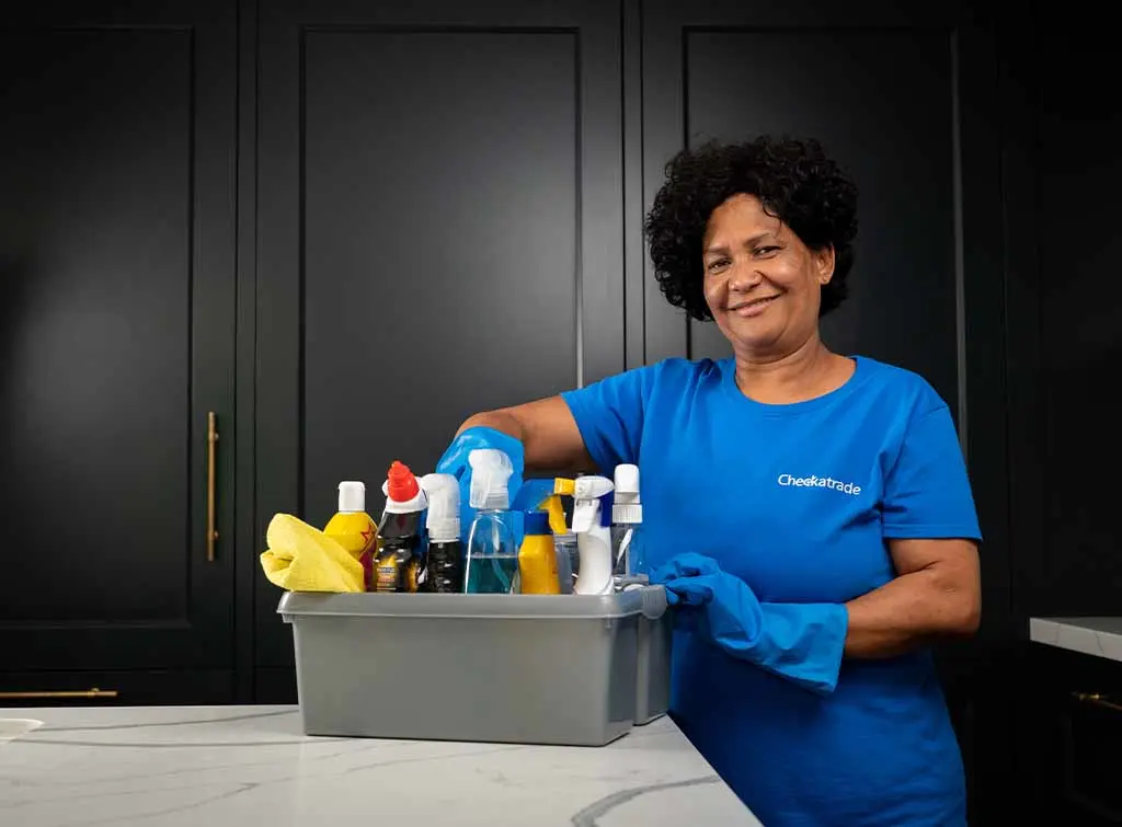 Cleaner with a caddy of cleaning supplies